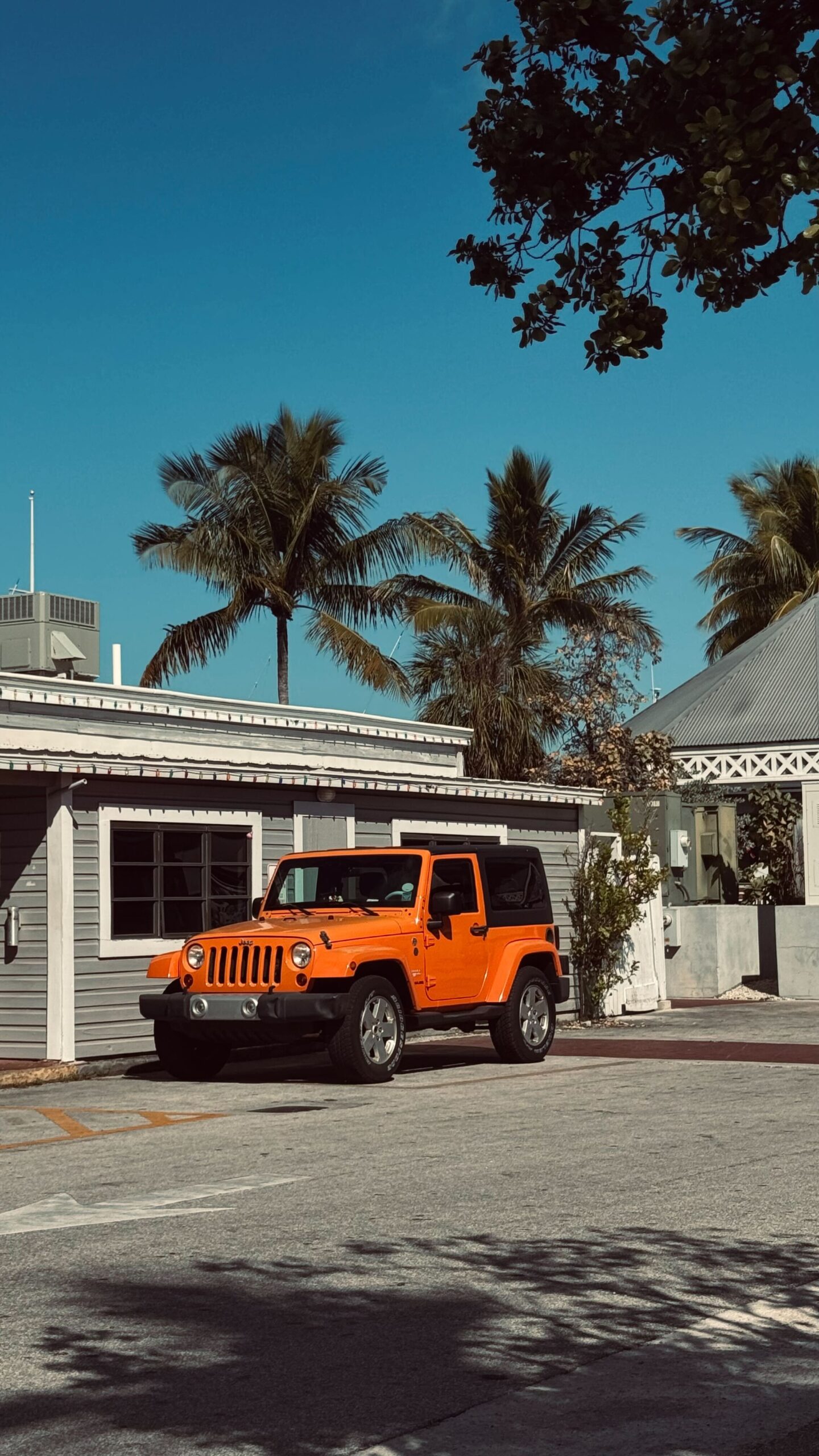 orange jeep parked in front of building